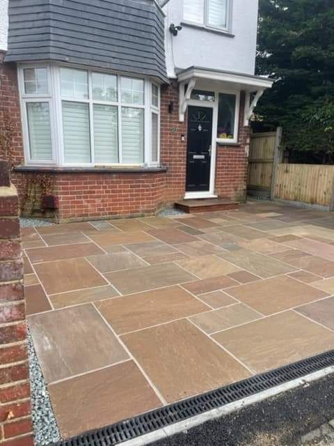 Paved entrance outside a brick house